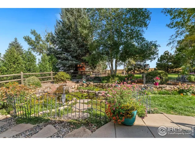 a view of yard with flowers and green space