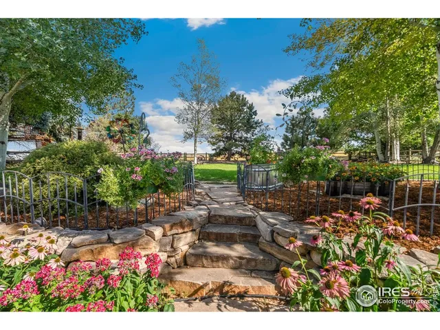 a view of a house with a yard and garden