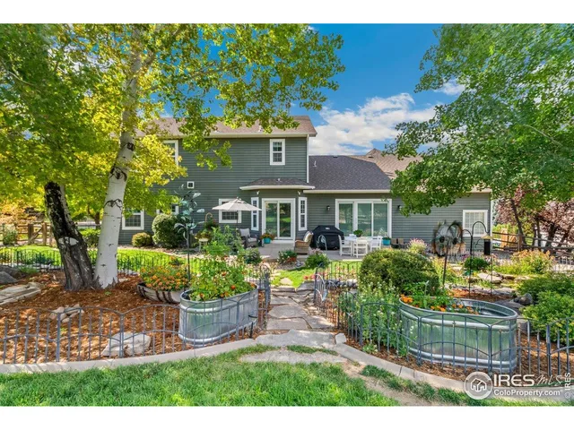 a view of a house with backyard sitting area and garden