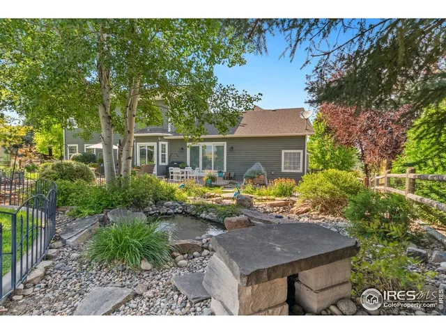 a view of a house with backyard and sitting area