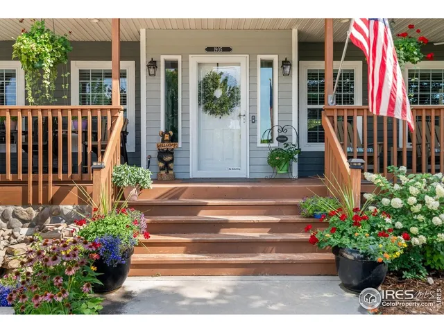 a view of a house with potted flower plants