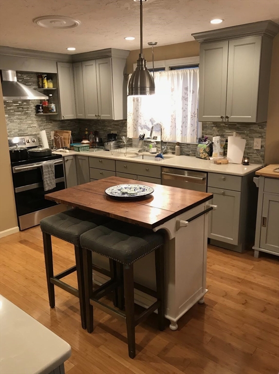 303 Lexington Street, Unit 303 Watertown, MA 02472 - Photo 1 of 13 a kitchen with a table chairs sink and cabinets