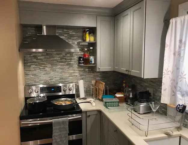a kitchen with a stove and a cabinets