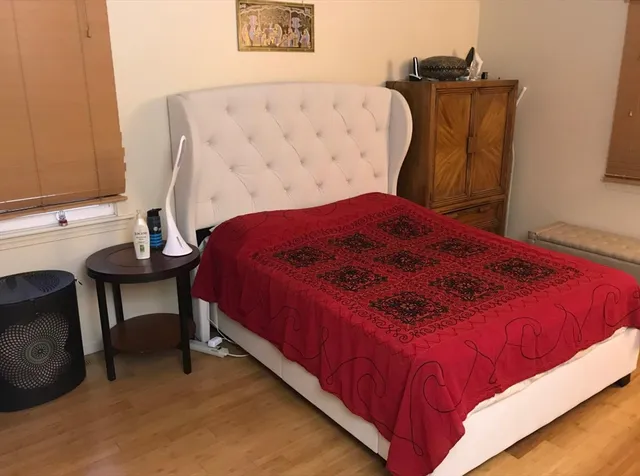 a bedroom with a bed and a chair in it