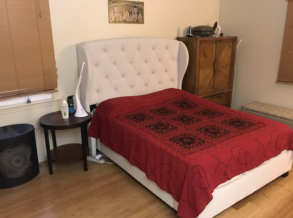 303 Lexington Street, Unit 303 Watertown, MA 02472 - Photo 6 of 13 a bedroom with a bed and a chair in it