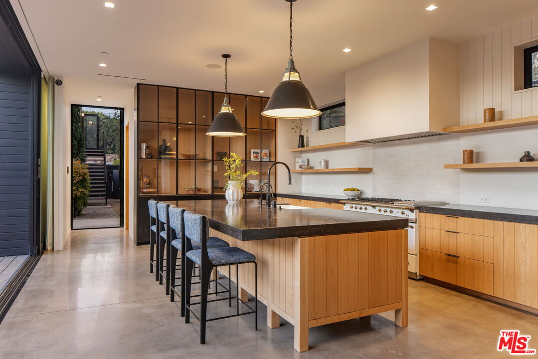 901 Flower Avenue Venice, CA 90291 - Photo 13 of 48 a kitchen with stainless steel appliances granite countertop a sink a stove and a refrigerator