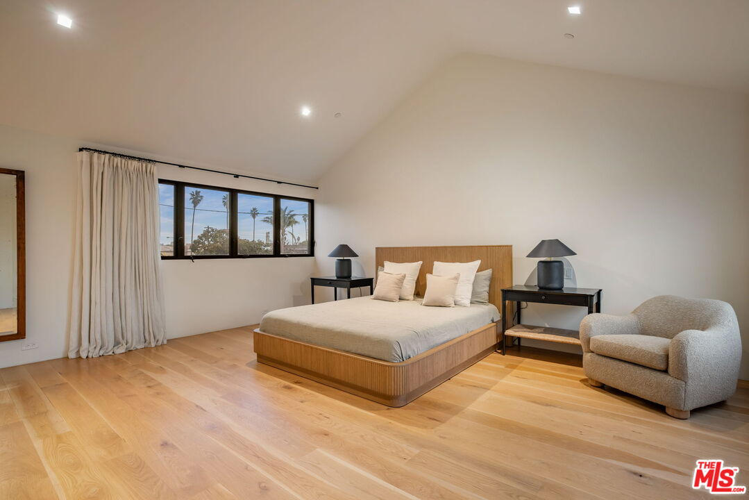 901 Flower Avenue Venice, CA 90291 - Photo 9 of 16 a bedroom with a bed and wooden floor