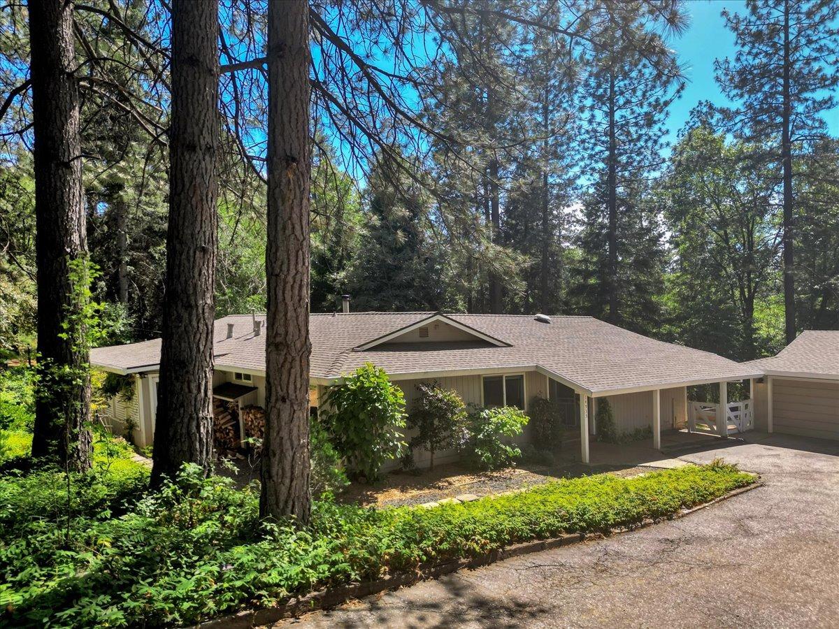14933 Chattering Pines Road Grass Valley, CA 95945 - Photo 1 of 1 a front view of a house with garden