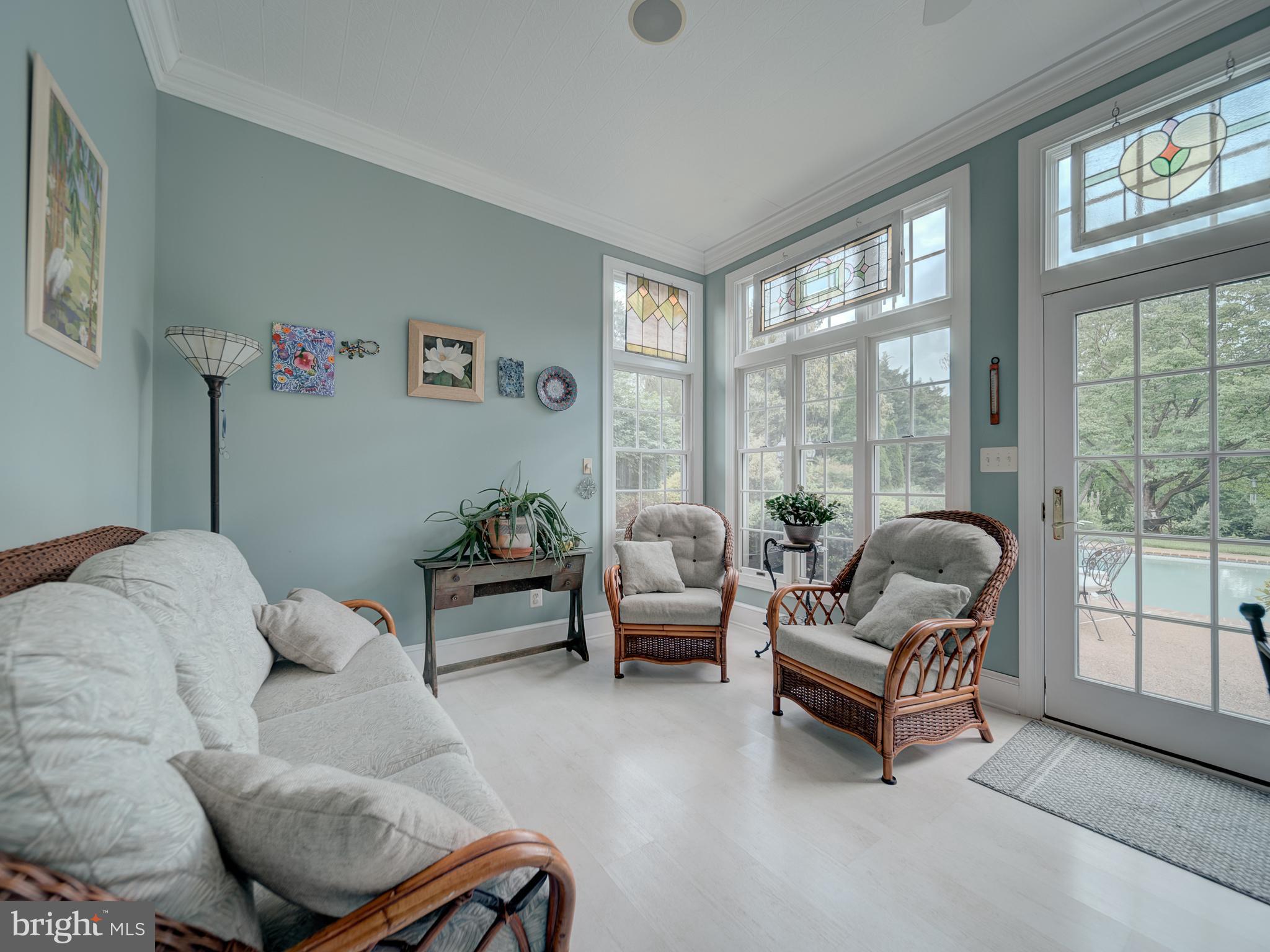 4387 Stepney Drive Gainesville, VA 20155 - Photo 17 of 74 a living room with furniture and a floor to ceiling window
