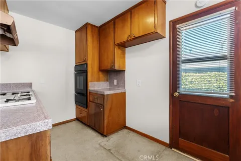 a kitchen with stainless steel appliances granite countertop a refrigerator and a stove