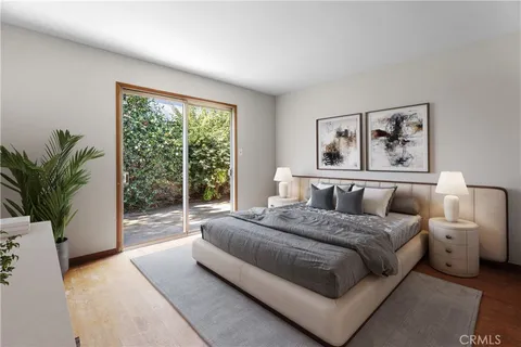 a bedroom with a large bed and a large window