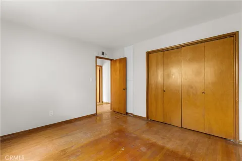 a view of an empty room with closet area