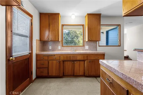 a kitchen with granite countertop a sink and a stove