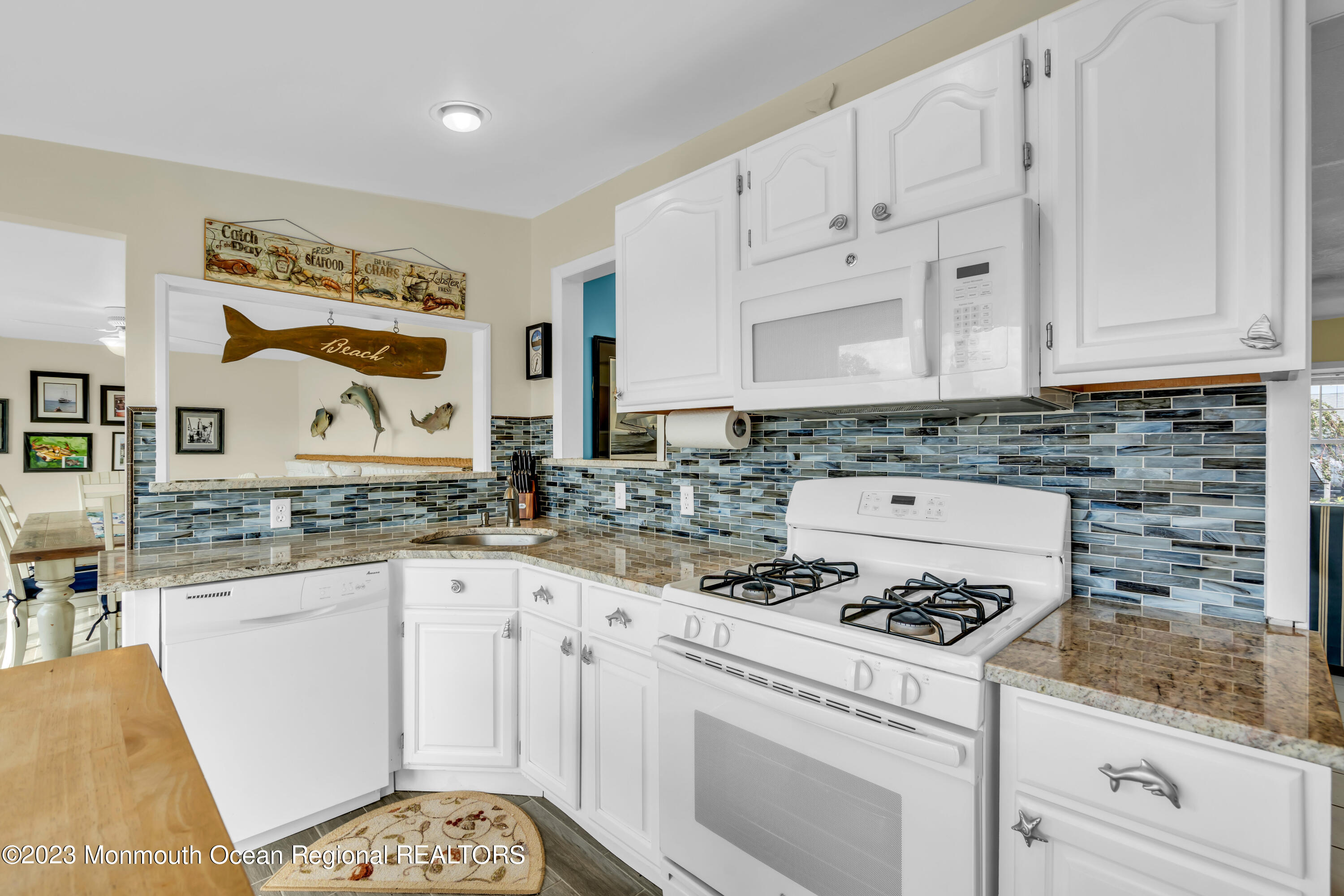 112 Newark Road Barnegat, NJ 08005 - Photo 18 of 44 a kitchen with granite countertop a sink a stove a oven and white cabinets