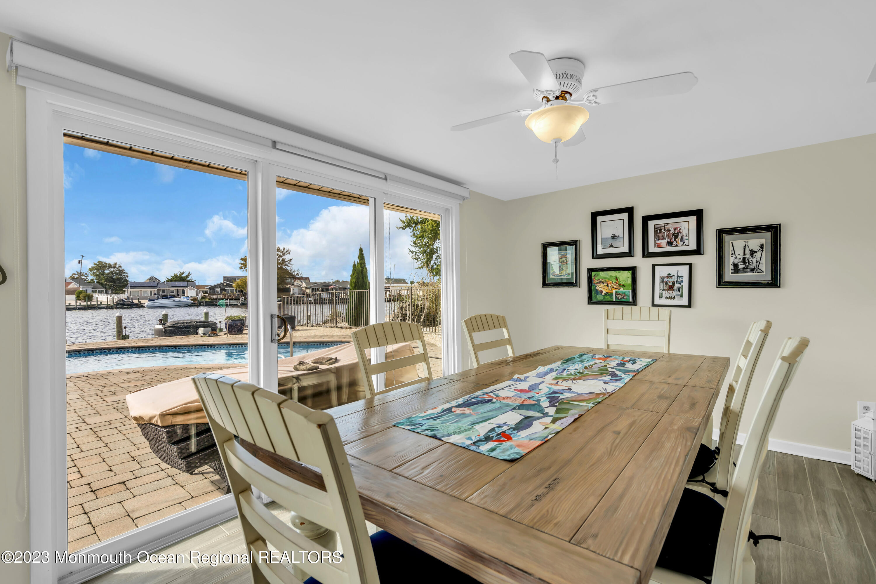 112 Newark Road Barnegat, NJ 08005 - Photo 23 of 44 a view of a dining room with furniture a chandelier and wooden floor