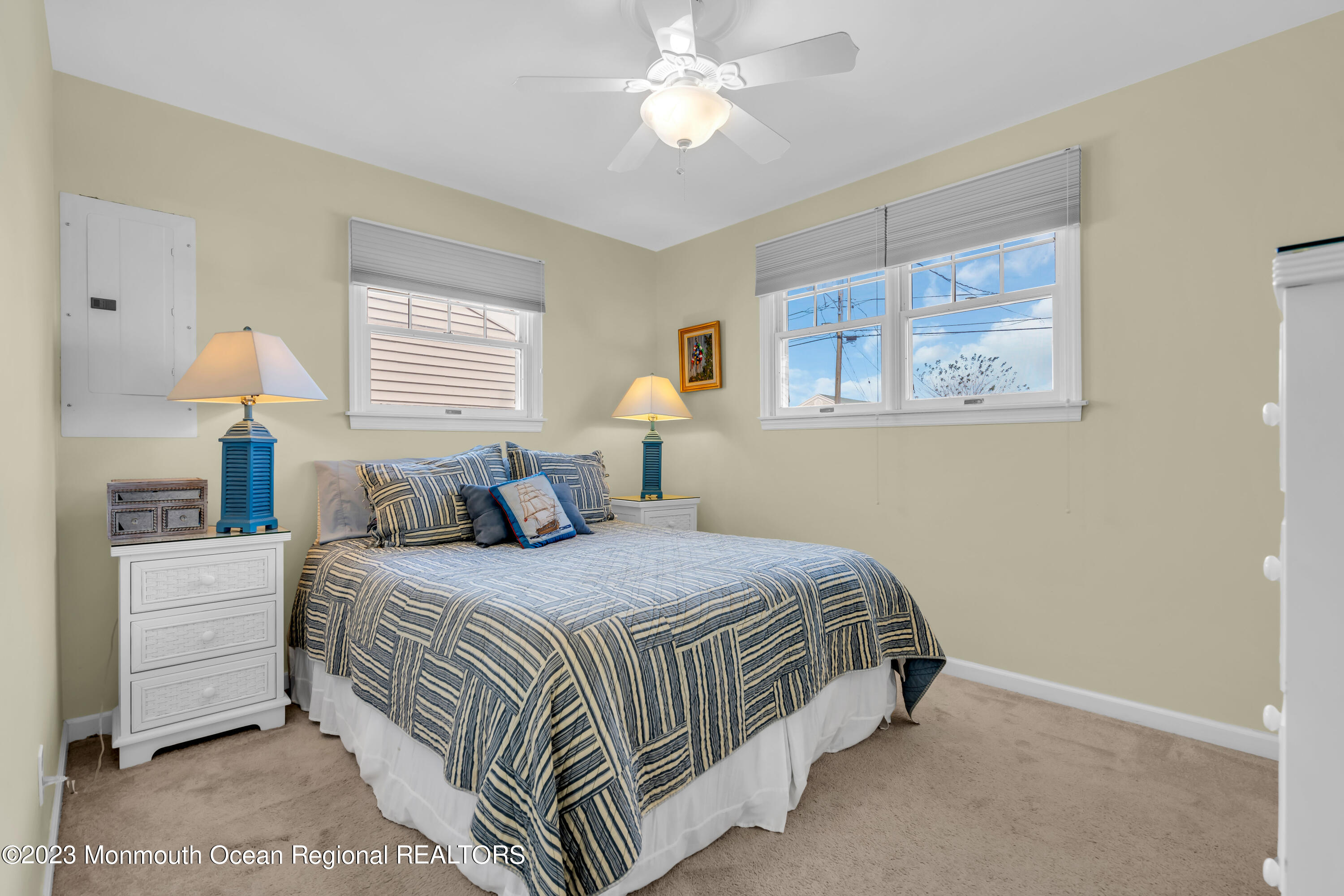 112 Newark Road Barnegat, NJ 08005 - Photo 26 of 44 a bedroom with a bed and a chandelier