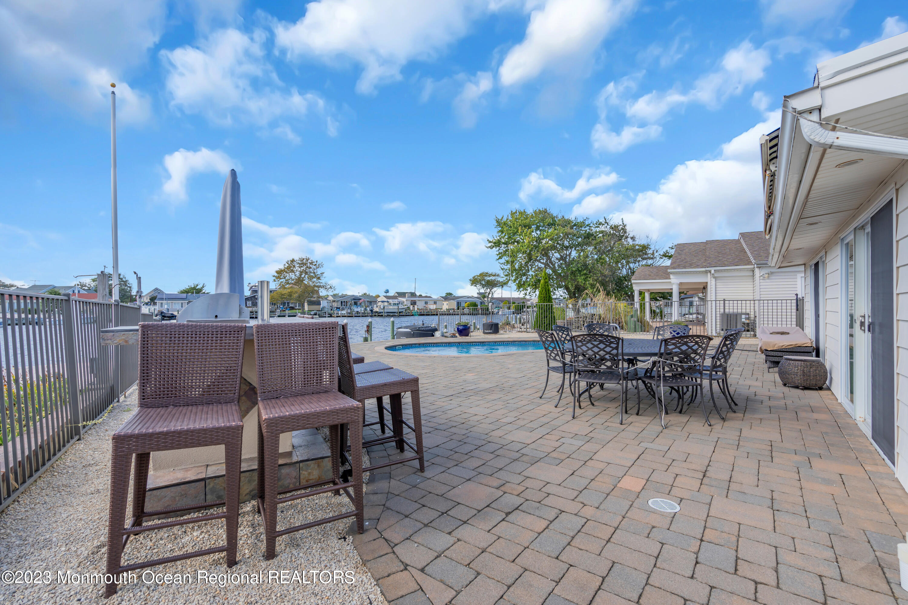 112 Newark Road Barnegat, NJ 08005 - Photo 32 of 44 a view of a patio with a dining table and chairs