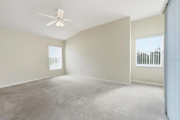 a spacious bathroom with a double vanity sink a mirror and a toilet