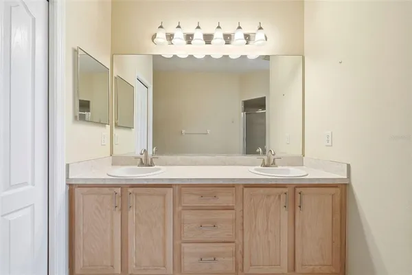 an empty room with a window and a ceiling fan