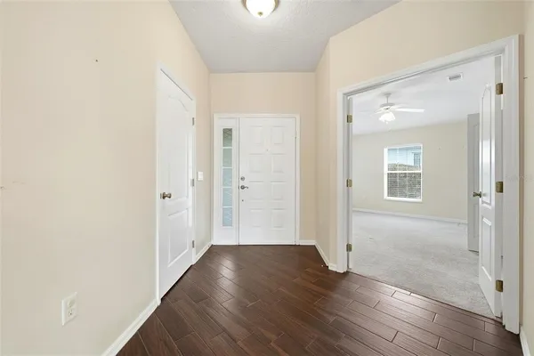 a view of a hallway with wooden floor