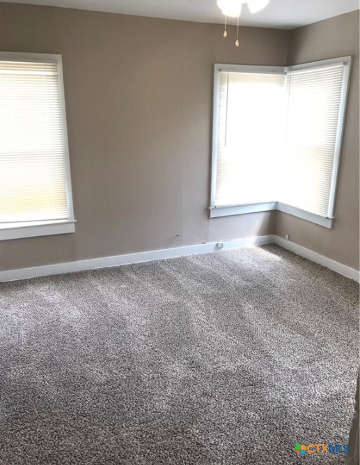 305 East Sabine Street, Unit A Victoria, TX 77901 - Photo 5 of 6 an empty room with a window
