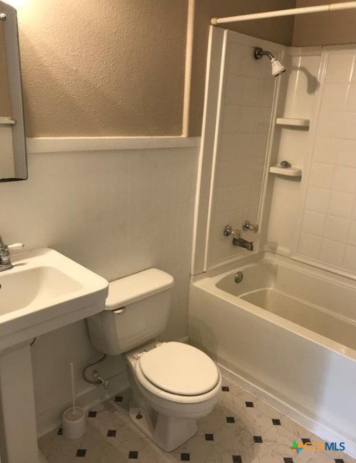 305 East Sabine Street, Unit A Victoria, TX 77901 - Photo 6 of 6 a white toilet sitting next to a bath tub