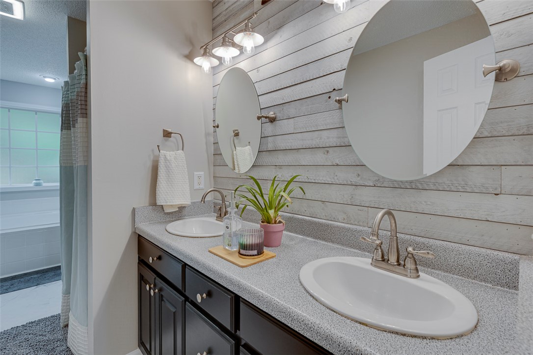 121 Crimson Leaf Lane Liberty, SC 29657 - Photo 12 of 30 This bathroom features dual vanities set against a charming shiplap accent wall.