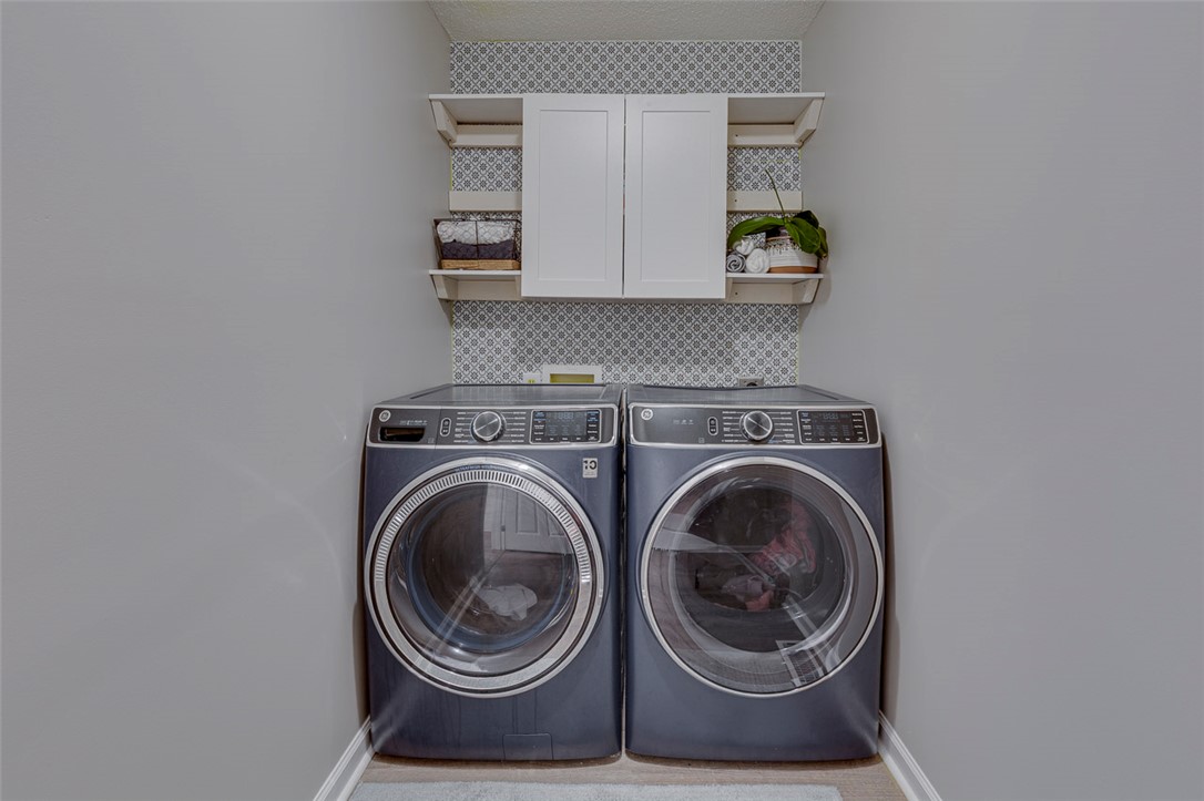121 Crimson Leaf Lane Liberty, SC 29657 - Photo 20 of 30 This dedicated laundry space combines modern appliances with smart storage solutions.