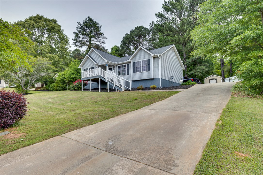 121 Crimson Leaf Lane Liberty, SC 29657 - Photo 2 of 30 Charming home features an inviting porch, spacious yard, and a long driveway leading to a convenient shed.