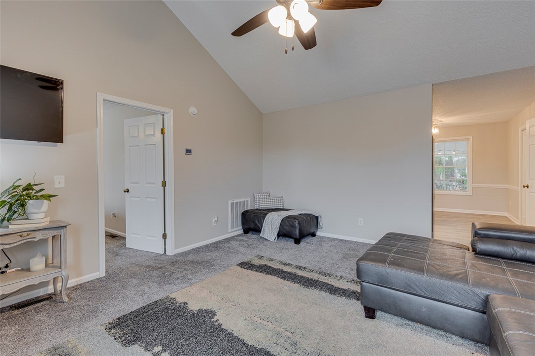 121 Crimson Leaf Lane Liberty, SC 29657 - Photo 8 of 30 This living room features vaulted ceilings and carpet flooring.