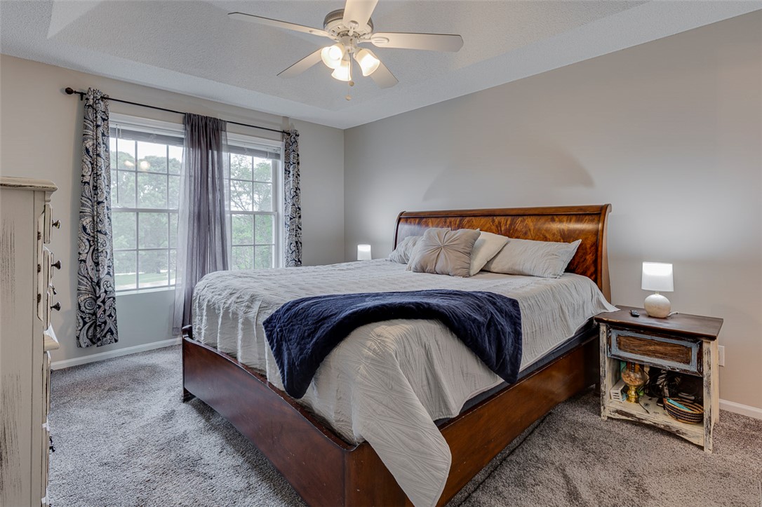 121 Crimson Leaf Lane Liberty, SC 29657 - Photo 9 of 30 This inviting bedroom features a tray ceiling, ceiling fan, and soft carpeting.