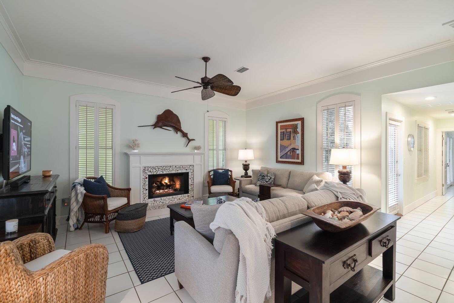 224 Rue Caribe Miramar Beach, FL 32550 - Photo 13 of 67 a living room with furniture a fireplace and a flat screen tv