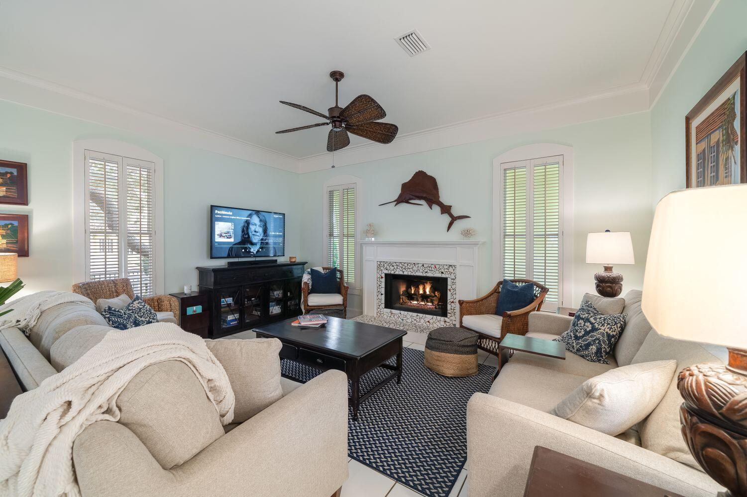 224 Rue Caribe Miramar Beach, FL 32550 - Photo 14 of 67 a living room with furniture a fireplace and a flat screen tv