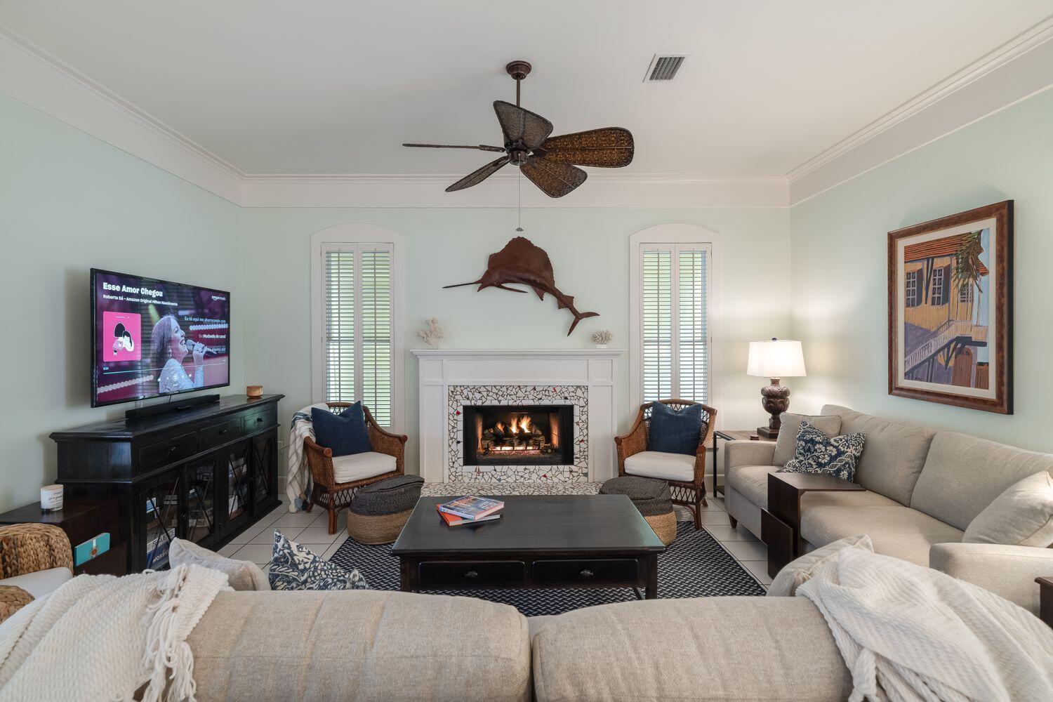 224 Rue Caribe Miramar Beach, FL 32550 - Photo 15 of 67 a living room with furniture a fireplace and a flat screen tv