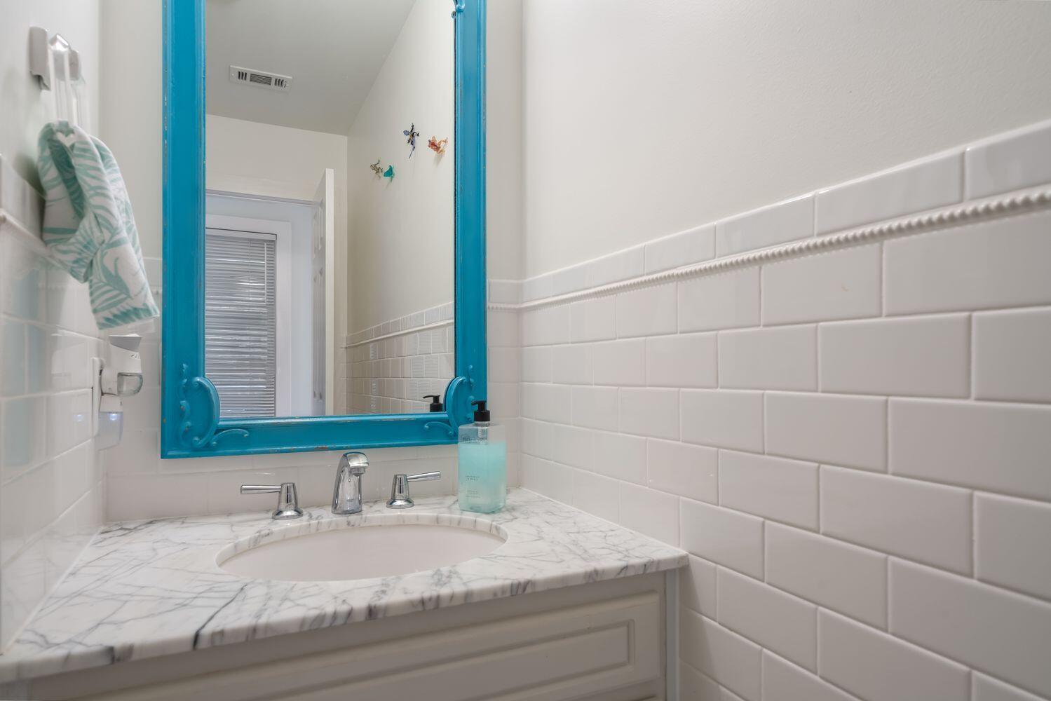 224 Rue Caribe Miramar Beach, FL 32550 - Photo 24 of 67 a bathroom with a granite countertop sink and a mirror