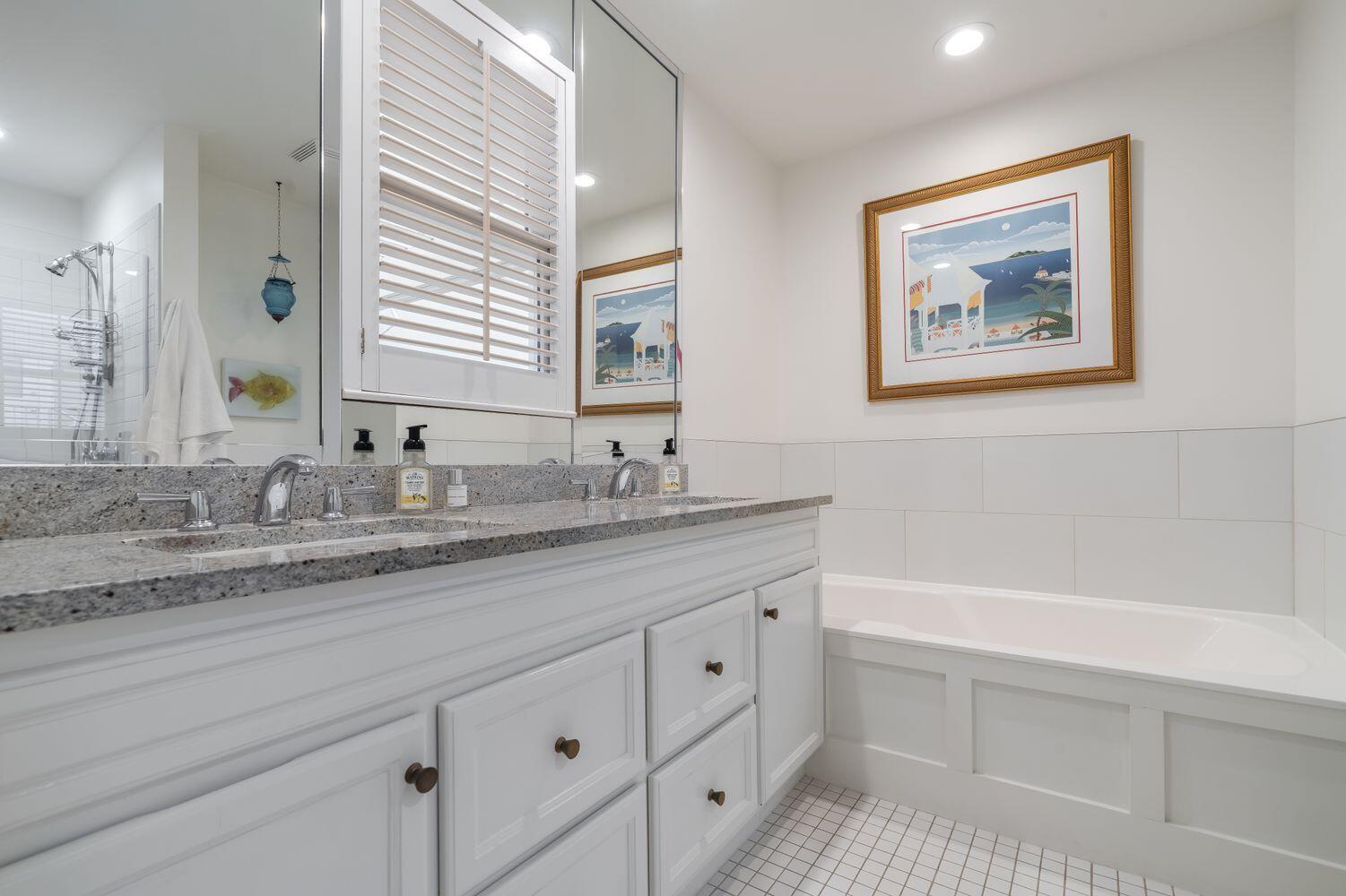 224 Rue Caribe Miramar Beach, FL 32550 - Photo 29 of 67 a bathroom with a granite countertop sink mirror and bathtub