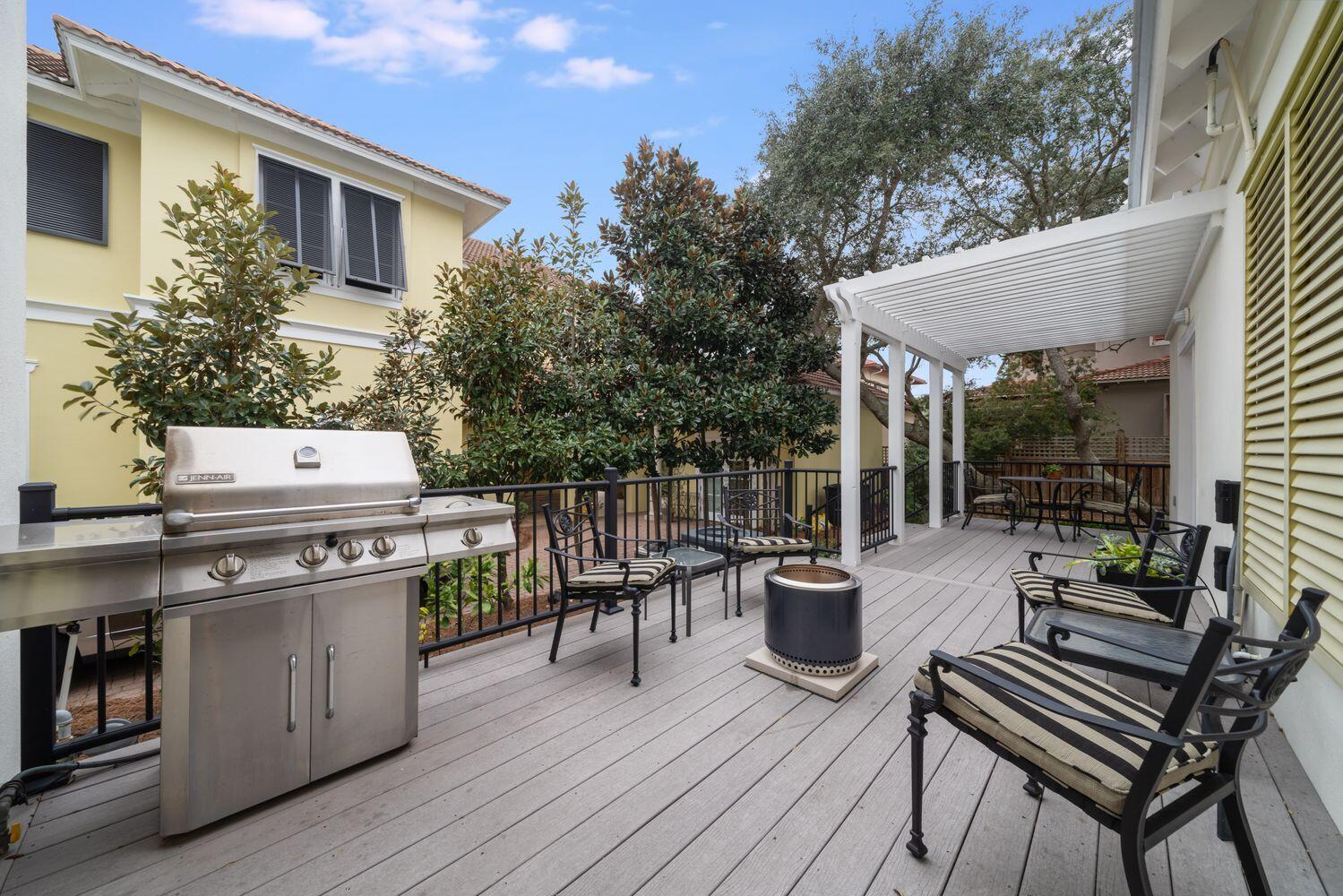224 Rue Caribe Miramar Beach, FL 32550 - Photo 44 of 67 a view of a patio with table and chairs with wooden floor and fence