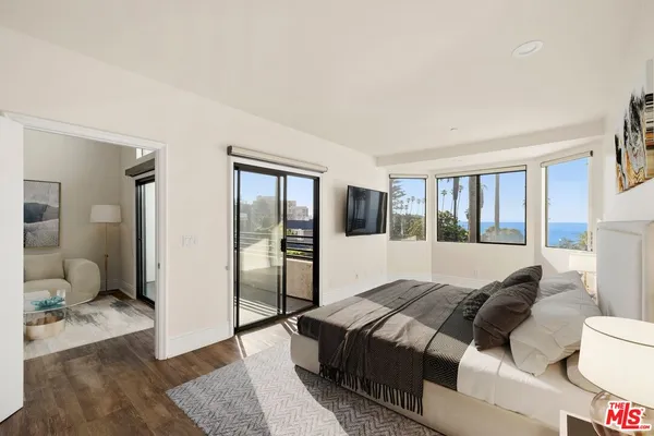 a spacious bedroom with a large bed and a couch