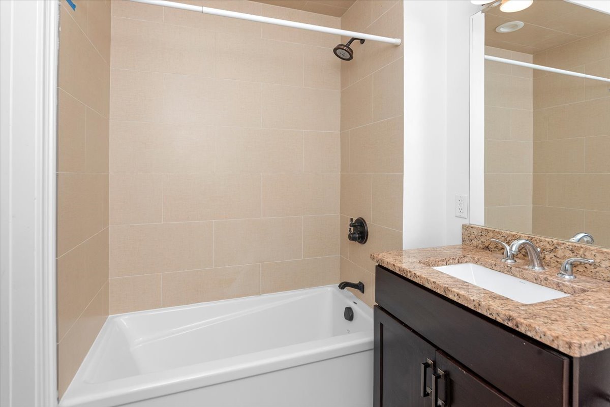 2500 Green Bay Road, Unit 403 Evanston, IL 60201 - Photo 11 of 16 a bathroom with a granite countertop sink and a bathtub