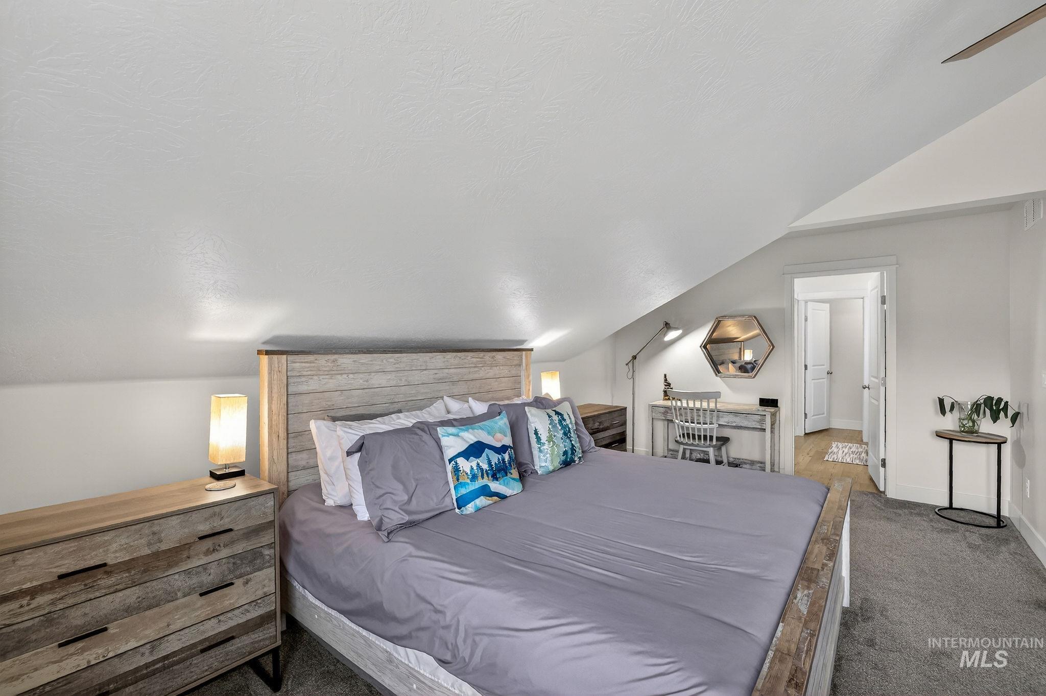 311 Broken Ridge Way McCall, ID 83638 - Photo 24 of 44 Bedroom featuring sloped ceilings, light gray wall finishes, and gray carpet flooring