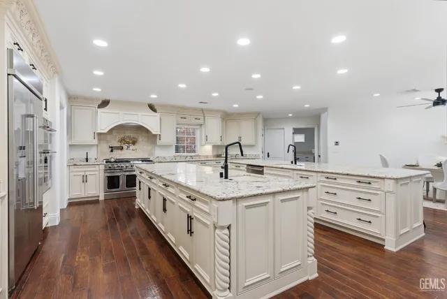 a kitchen with white cabinets stove and kitchen island