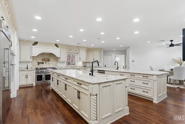 a large kitchen with kitchen island a dining table and chairs