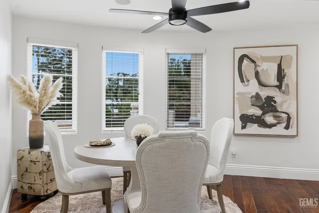 a kitchen with appliances and chairs in it