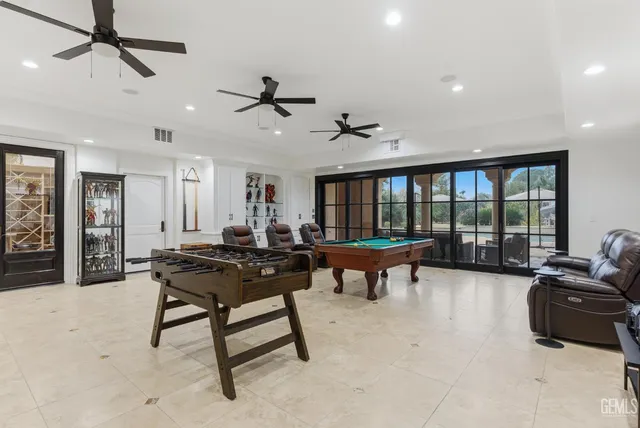 a spacious bedroom with a bed and a chandelier
