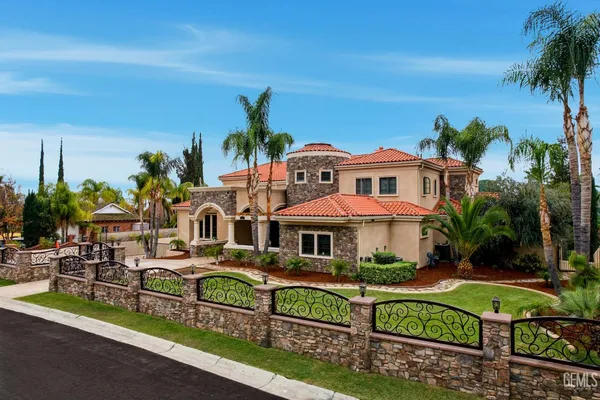 a large kitchen with stainless steel appliances granite countertop a large counter top a stove and a sink