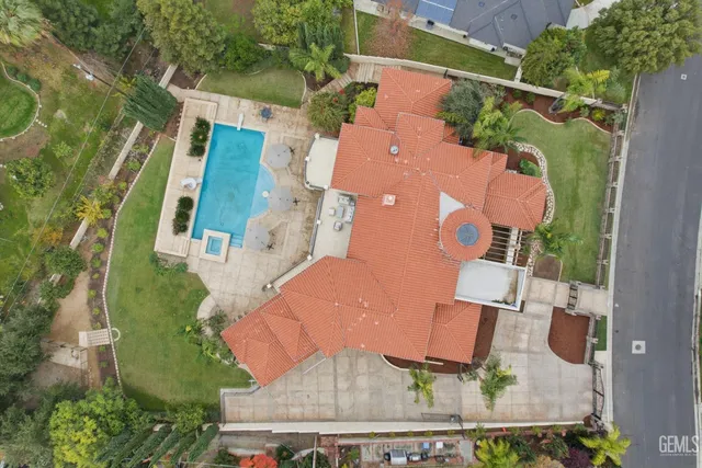 an aerial view of residential houses with outdoor space and trees