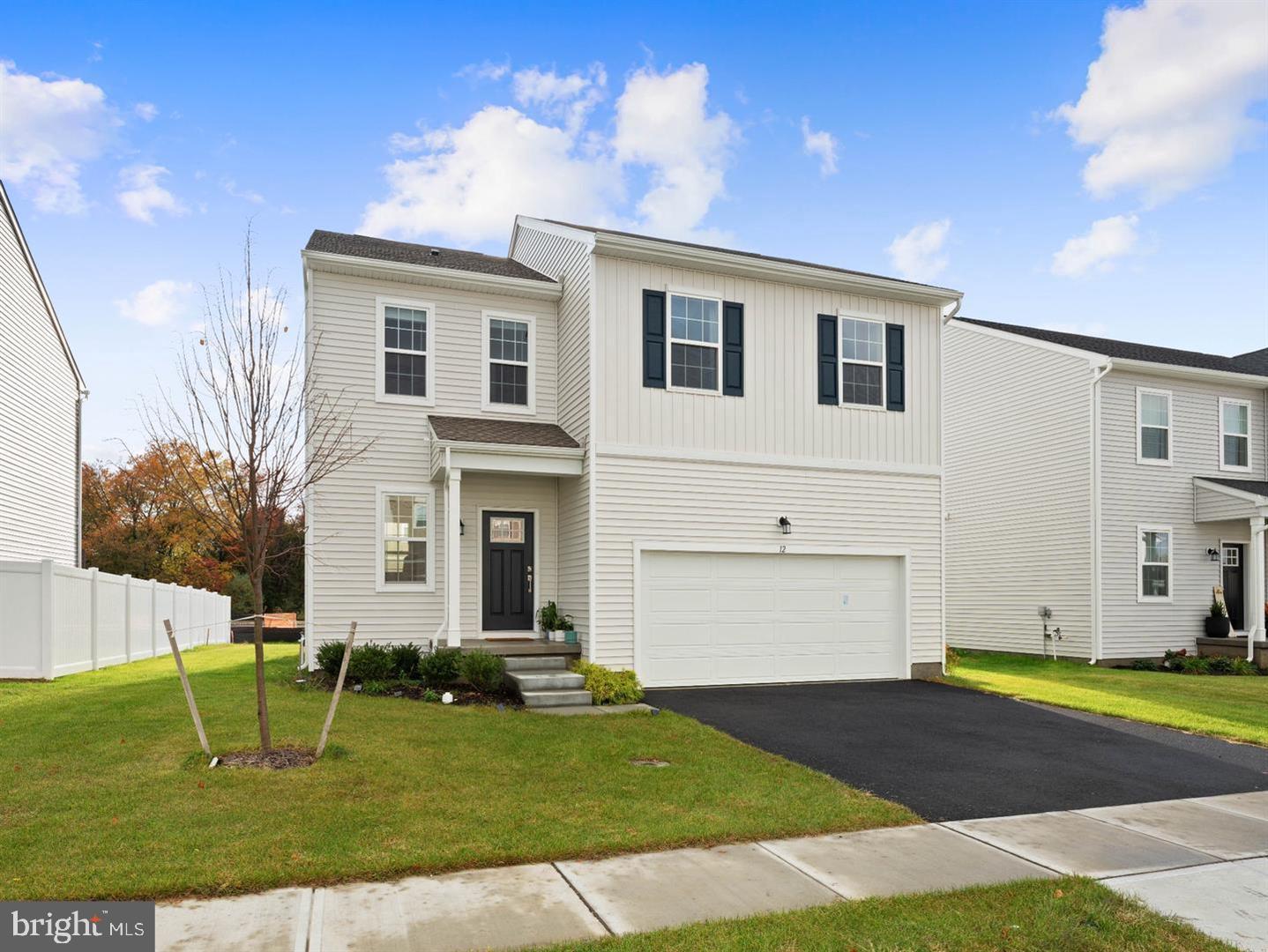 12 Handbell Lane Sicklerville, NJ 08081 - Photo 2 of 30 a front view of a house with a yard and garage