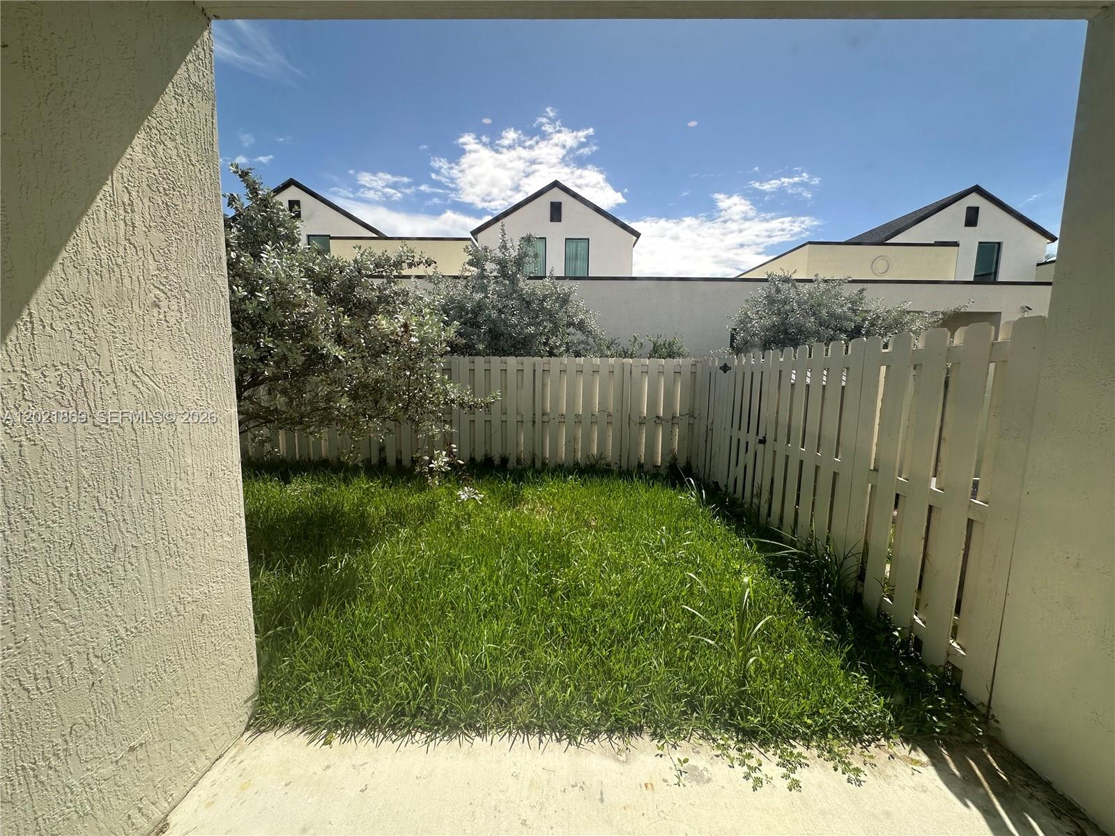 23935 Southwest 110th Court, Unit 23935 Homestead, FL 33032 - Photo 9 of 10 a view of a pathway of a house with a yard