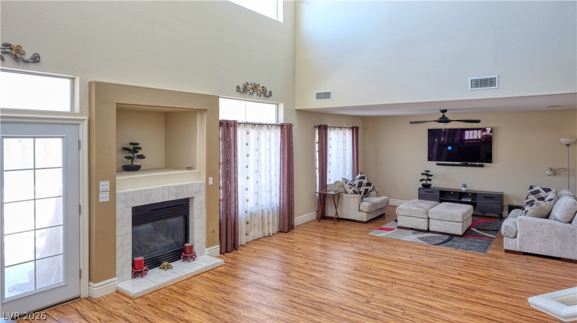 3704 North Campbell Road Las Vegas, NV 89129 - Photo 4 of 38 A welcoming family area boasts soaring ceilings and a cozy fireplace, perfect for gatherings.