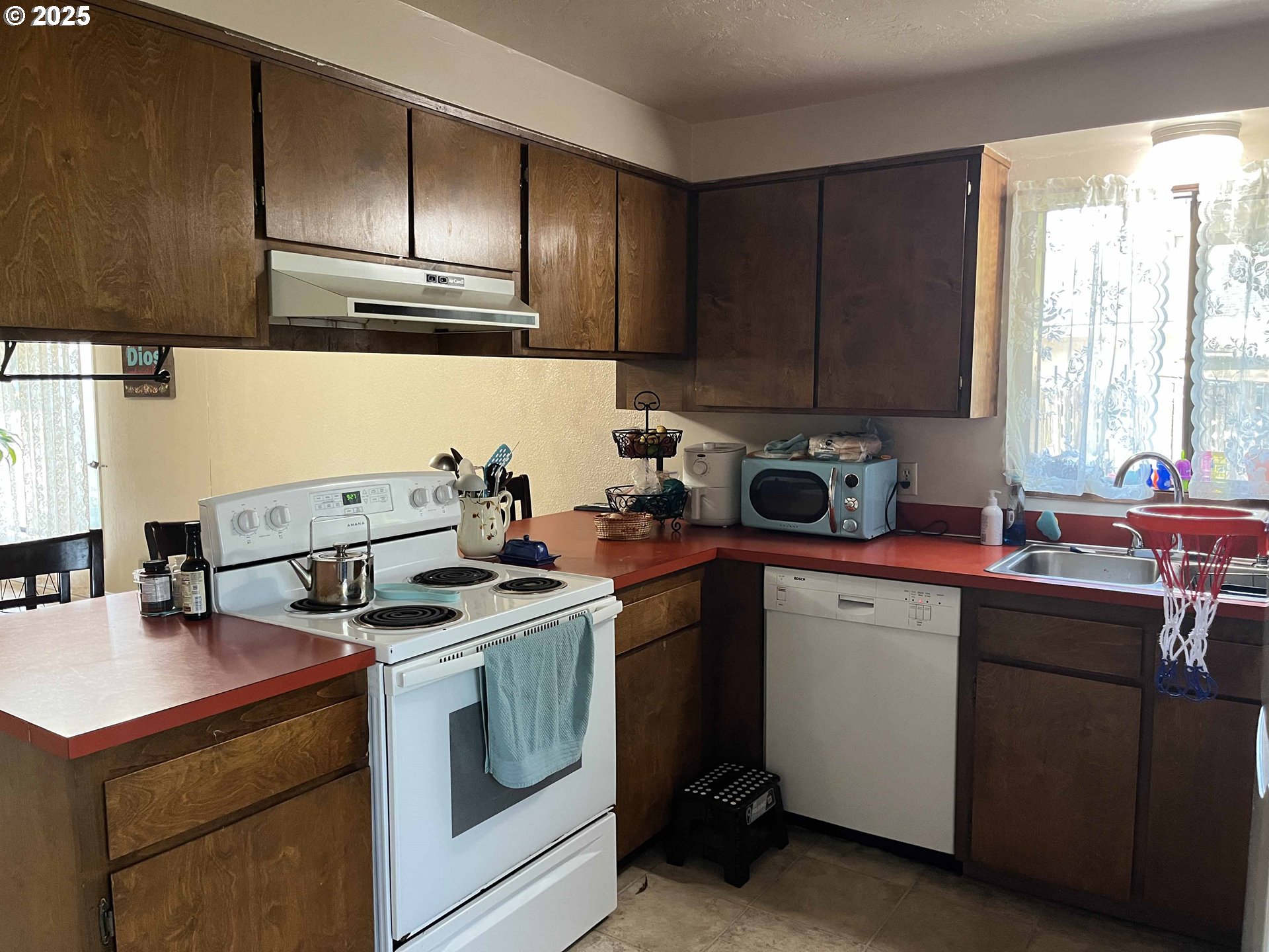 2215 24th Street Florence, OR 97439 - Photo 17 of 31 a kitchen with cabinets appliances a sink and a window